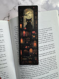 Black cat bookmark featuring a spooky moonlit library scene
